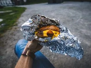 A burger wrapped in aluminum tin foil